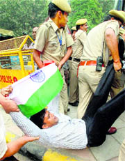 Cops drag a protester during a convention of Hurriyat Conference chairman Syed Ali Shah Geelani in New Delhi on Thursday.