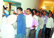  Applicants waiting for their turn to get photographs clicked at the District Transport Office in Amritsar. 