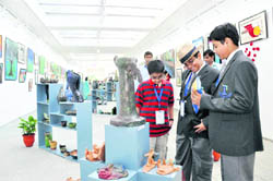 Students look at the exhibits at the Doon School art gallery in Dehradun
