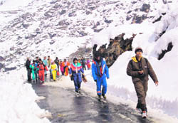 Tourists, who were stranded at Marhi on the Manali-Rohtang road, near the Rahala waterfall, 27 km from Manali, on Saturday. They were brought to Manali by a rescue team