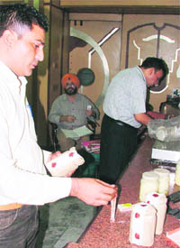 Health officials collect khoya samples from a shop in Ludhiana on Saturday.
