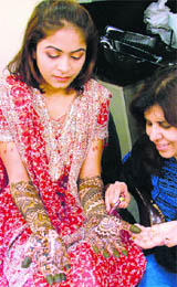 A woman gets henna applied to her hands ahead of Karva Chauth in Ludhiana.