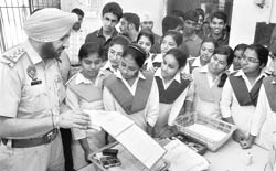 Division No. 2 police station SHO Surinder Mohan shows an FIR to visting schoolchildren in Ludhiana on Saturday.