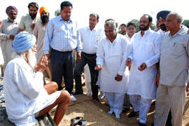 Pala Singh, an elderly farmer from Multania village, making an appeal to the Congress MLA Harminder Singh Jassi to help him get his paddy crop procured at the grain market in Bathinda on Saturday.