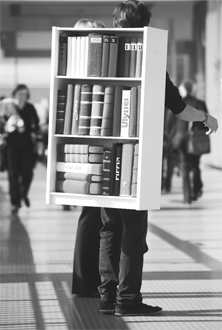 A man walks with a mock shelf on his back at the recent book fair in Frankfurt, central Germany Photo: AFP 