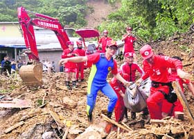 Megi fury in Taiwan: Rescue team members at work after Typhoon Megi caused landslides in Suao, northern Taiwan