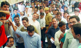 People stand in queues to submit their challans during the mega Lok Adalat at Patiala House Courts in New Delhi on Sunday.