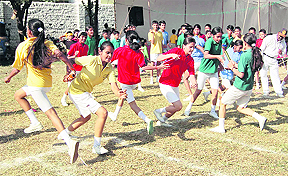 Students participate in a relay race at Marshall School in Dehradun on Sunday.
