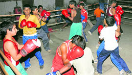 Young members of the Bhiwani Boxing Club, which is a makeshift boxing arena. A single hand pump is its only source of water for the 1,000-odd boys who practice there twice a day for hours together.