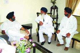 Deputy Chief Minister Sukhbir Badal interacts with veteran Akali leader Kuldip Singh Wadala (centre) at the latters residence