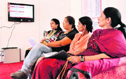 Viewers watch an LCD screen put up by the police in Ludhianaon Sunday.