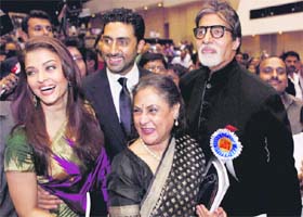 Bollywood actors Amitabh Bachchan poses with his family after receiving the Best Actor award for Paa