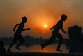 RUN FOR FUN: Boys in a playful mood near a thermal lake in Bathinda on Monday evening