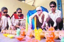 Students of the institute for the blind make candles for Diwali at Sector 26, Chandigarh, on Monday.