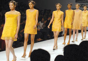 Models display the creation by Indian designers Manish Gupta during the Wills Lifestyle India Fashion Week - Spring Summer at Pragati Maidan in New Delhi on Monday.