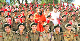 Yoga guru Baba Ramdev with NCC cadets in Dehradun on Monday.