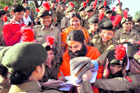 Yoga Guru Baba Ramdev signs autographs for NCC cadets in Dehradun on Monday.