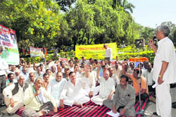 Sugarmill employees stage a dharna at the Gandhi Park in Dehradun on Monday.