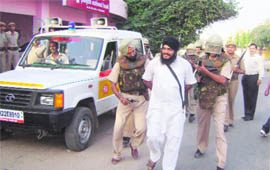 Cops apprehend a terrorist during a mock exercise at Fatehabad on Monday.