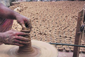 A porter makes earthen lamps ahead of Diwali in Ambala Cantt