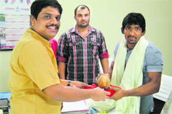 Ajit Joshi, deputy commissioner, congratulates wrestler Yogeshwar Dutt at his office in Sonepat. 
