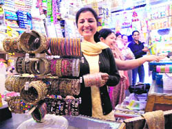 FESTIVE SPIRIT: Women choose bangles on the eve of Karva Chauth at Kotwali Bazaar in Dharamsala. 