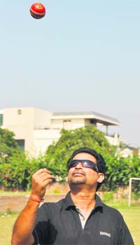 Former cricketer Chetan Sharma tosses a ball during his visit to Ludhiana