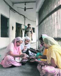 Inmates of the women jail apply heena on their hands in Ludhiana