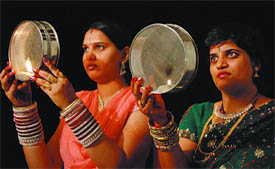 Women  watching the moon through sieves before ending their Karva Chauth fast in Bathinda late on Tuesday evening.