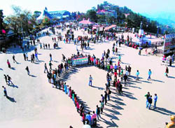 Activists of an NGO, Youth Power of India, form a human chain during a protest against corruption, at the Ridge in Shimla on Tuesday. 