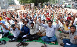 Employees of the Municipal Corporation, Bathinda, hold a rally outside the MC office on Wednesday
