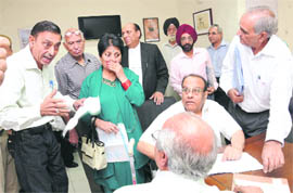 Agitated Sector 45 residents argue with a staff member at the CHB secretary’s office.