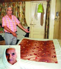 Son of the victim, Maya Devi (inset), shows the bed where she was found dead at Rani Bagh