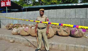 A policeman keeps vigil in the Khoya-Paneer Market following a raid in view of the festive season in Old Delhi
