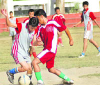 Players vie for the ball in a match of the ONGC Ram Bahadur Chetri Memorial Inter-School Football Tournament in Dehradun