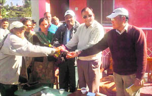Uttarakhand Kranti Dal leaders distribute relief material among victims of natural disaster in Pitthoragarh on Wednesday. 