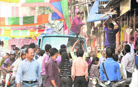 Police and Dehradun Municipal Corporation staff remove encroachments at Paltan Bazar in Dehradun on Wednesday.