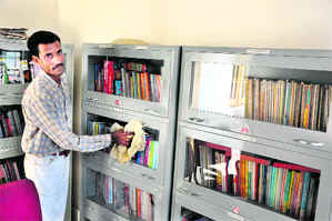 Hazara Ram, the peon-cum-cleaner, at work at the memorial library in Rajinderpura village in Samba district.