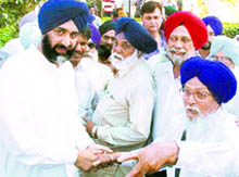 Former Punjab Finance Minister Manpreet Singh Badal meets people after addressing a public at Hazara village, near Jalandhar, on Wednesday