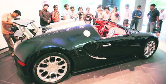 Onlookers ogle at the Bugatti Veyron 16.4 Grand at its India launch in New Delhi