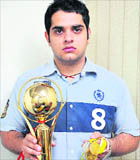 Budding shooter Shivendu Sharma shows the trophy and medals that he claims to have won during the Chandigarh State Shooting Championship.