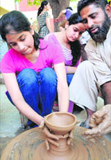 A girl tries a hand at a pottery competition at MCMDAV College, Sector 36, Chandigarh, on Thursday.