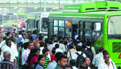People jostle to get on a DTC bus at the ITO bus stop as Bluelines were removed from Delhi roads 