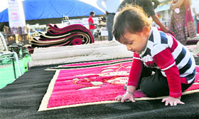 A child plays while his parents shop at the Uttarakhand Mahotsav in Dehradun.