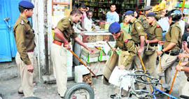 The police removes encroachments from the Paltan Bazar in Dehradun on Thursday.