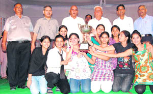 Group photo of GVM girl students holding the overall champion trophy. (From left) Gohana College principal SN Sharma, Dr Dev Swarup and MLAs Jagbir Singh Malik and Sri Krishan are also seen standing behind the students.