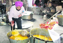 District health officer Dr Jagpal Singh shows the sustandard ingredients used in the making of pattisa, a sweetmeat supplied to noted retail outlets.