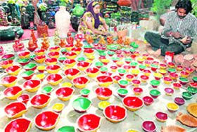 Potters make earthen lamps to prepare for the approaching Diwali in Amritsar on Thursday. 