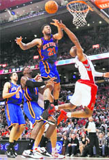 Toronto Raptors Jarrett Jack goes to the basket against New York Knicks' Wilson Chandler (21) during the second half of their NBA basketball game in Toronto