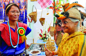 Chief Minister Sheila Dikshit poses with the traditional headgear of Arunachal Pradesh at ITBP Mela in New Delhi on Friday.